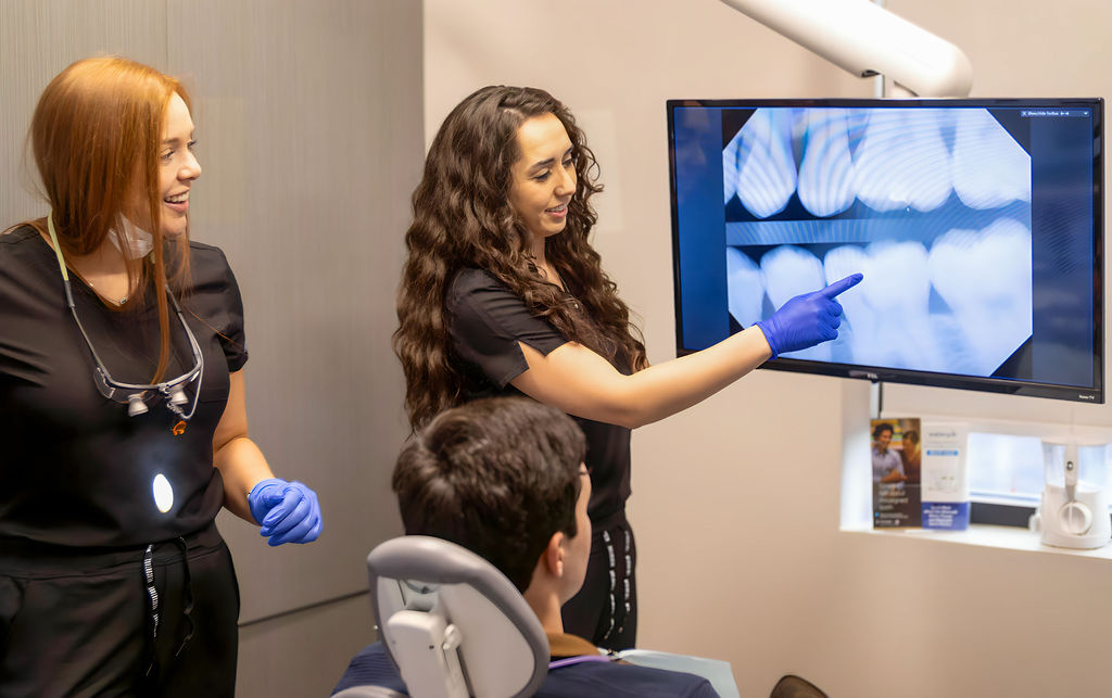 Neville Dental Studio | Dental Assistant Shows the Dental X-ray to the Patient